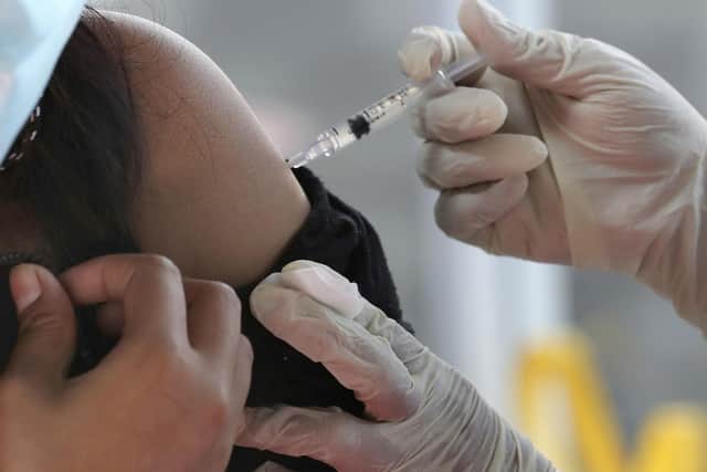 A person receives a dose of a Covid-19 vaccine. Picture: AP Photo/Tatan Syuflana