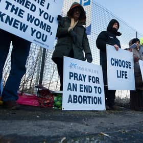 Members of the 40 Days For Life group hold a vigil as women head for appointments.