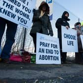 Members of the 40 Days For Life group hold a vigil as women head for appointments.