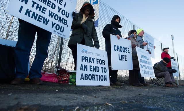 Members of the 40 Days For Life group hold a vigil as women head for appointments.