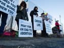 Members of the 40 Days For Life group hold a vigil as women head for appointments.