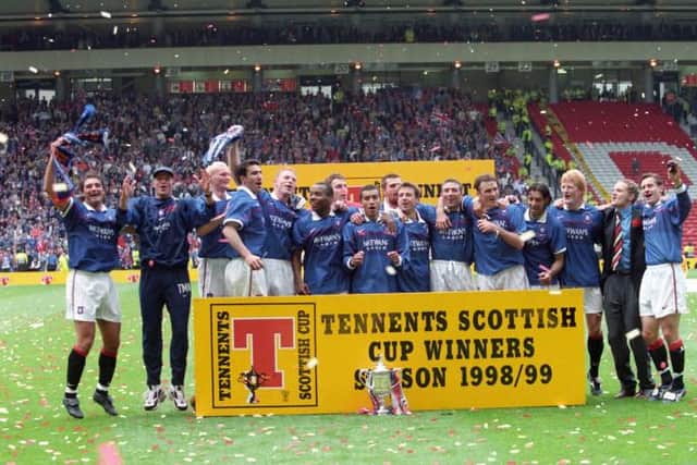 Giovanni van Bronckhorst (centre of photo) celebrating his first Scottish Cup triumph as a Rangers player after they defeated Celtic 1-0 in the 1999 final at Hampden. (Photo by SNS Group).