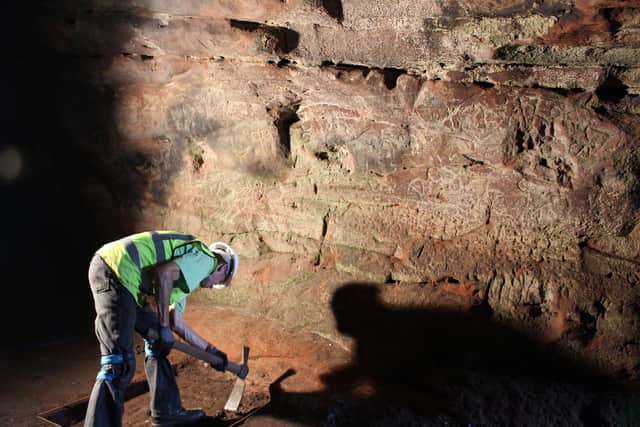 Excavation underway at Court Cave with a number of Pictish carvings visible on the wall. PIC: The SCAPE Trust.