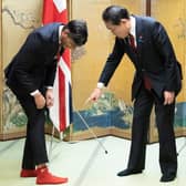 Prime Minister Rishi Sunak shows off his socks to Japanese Prime Minister Fumio Kishida, which has the name of Kishida's favorite baseball team, Hiroshima Toyo Carp. on them. Picture: Stefan Rousseau/AFP via Getty Images