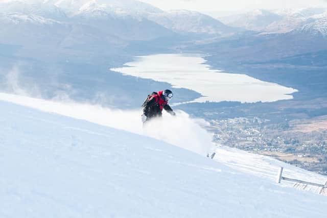Snowboarder Rhys Crilley from Glasgow, at Nevis Range, with Loch Eil in the distance