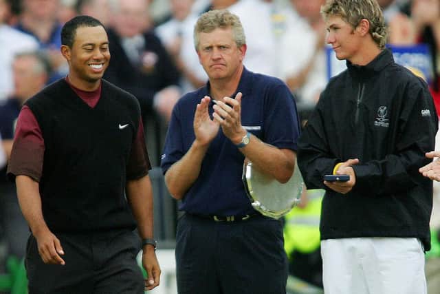 Silver Medal winner Lloyd Saltman, right, applauds along with Colin Montgomerie as Tiger Woods walks up to collect the Claret Jug after his win in the 2005 Open at St Andrews. Picture: Adrian Dennis/AFP via Getty Images.