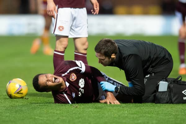 Hearts defender Toby Sibbick screams in pain during the match against Motherwell.