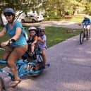A mum cycles with her two kids on the back. IF we all made such an effort with our young ones, the world would be a better - and cleaner - place, writes Hayley Matthews. PIC: Flickr/Mark Stosberg.