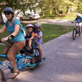 A mum cycles with her two kids on the back. IF we all made such an effort with our young ones, the world would be a better - and cleaner - place, writes Hayley Matthews. PIC: Flickr/Mark Stosberg.