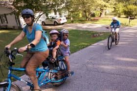 A mum cycles with her two kids on the back. IF we all made such an effort with our young ones, the world would be a better - and cleaner - place, writes Hayley Matthews. PIC: Flickr/Mark Stosberg.