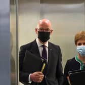 Scotland's First Minister Nicola Sturgeon and Education Minister John Swinney exit the lift. Picture: Russell Cheyne - WPA Pool/Getty Images
