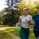 Happy athletic couple having fun while running together.