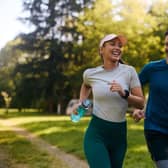 Happy athletic couple having fun while running together.