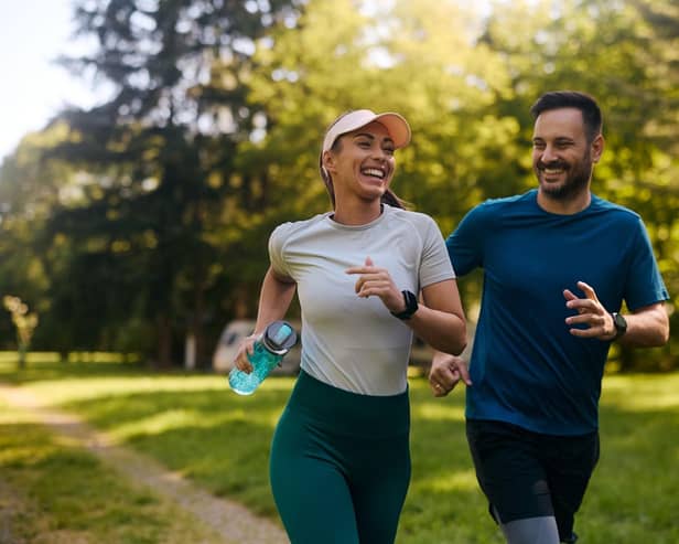 Happy athletic couple having fun while running together.