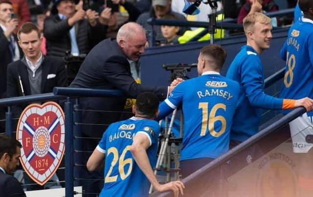 Ally McCoist congratulates the Rangers players as they go up to collect their Scottish Cup winners' medals at Hampden. (Photo by Craig Foy / SNS Group)