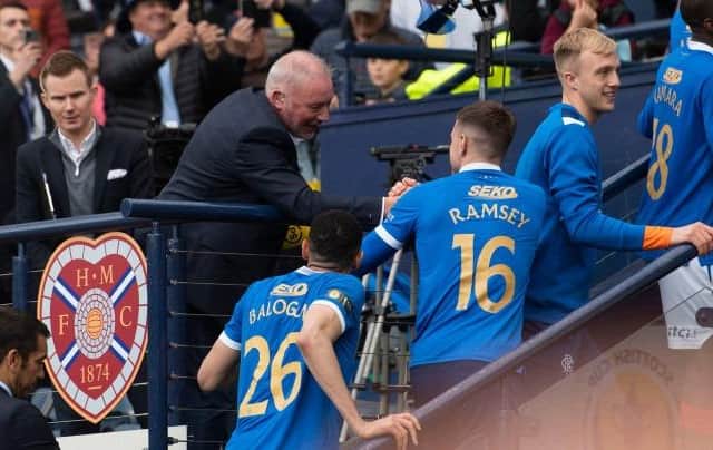 Ally McCoist congratulates the Rangers players as they go up to collect their Scottish Cup winners' medals at Hampden.  (Photo by Craig Foy / SNS Group)