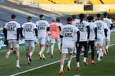 Leeds United players wear T-shirts with slogans against a proposed new European Super League during the warm up for a match against Liverpool (Picture: Clive Brunskill/pool/AFP via Getty Images)