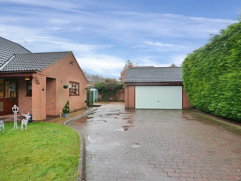 There is a good-sized, block-paved driveway with turning space and a detached double garage.