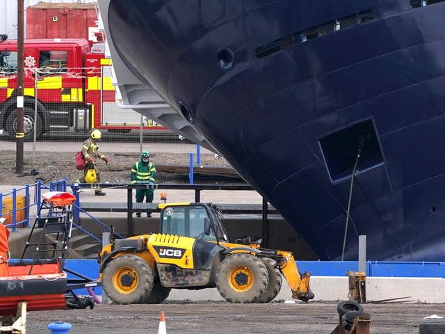 Emergency services at Imperial Dock in Leith, Edinburgh, where a ship has become dislodged from its holding and is partially toppled over.