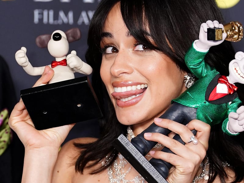 Camila Cabello in the press room with figurines of Wallace and Gromit during the 78th British Academy Film Awards