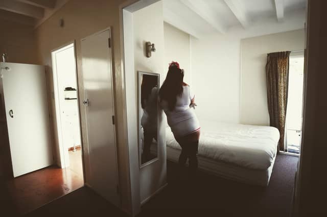 A 'sex worker' waits for her next booking to arrive at a brothel in New Zealand, where prostitution has been decriminalised (Picture: Hannah Peters/Getty Images)