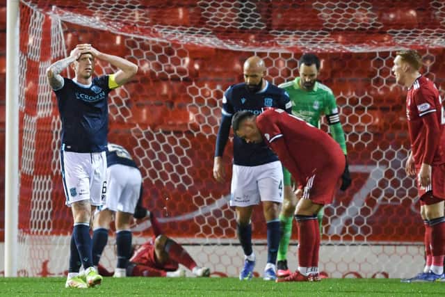 Jordan McGhee has his head in his hands after Dundee miss a chance during a Cinch Premiership match between Aberdeen and Dundee at Pittodrie Stadium, on December 26, 2021, in Aberdeen, Scotland. (Photo by Ross MacDonald / SNS Group)