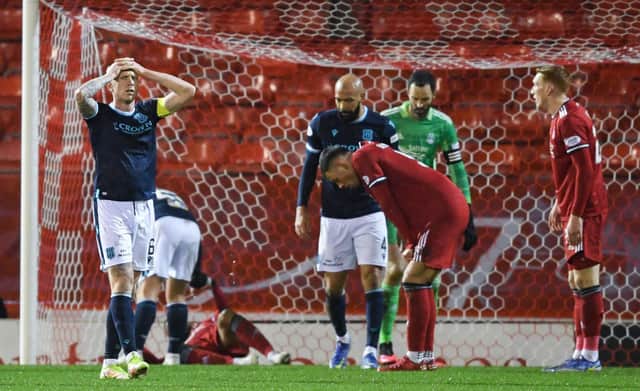 Jordan McGhee has his head in his hands after Dundee miss a chance during a Cinch Premiership match between Aberdeen and Dundee at Pittodrie Stadium, on December 26, 2021, in Aberdeen, Scotland. (Photo by Ross MacDonald / SNS Group)