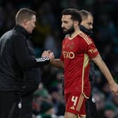 Aberdeen's Graeme Shinnie shakes hands with his manager Barry Robson after a chastening defeat at Celtic Park.