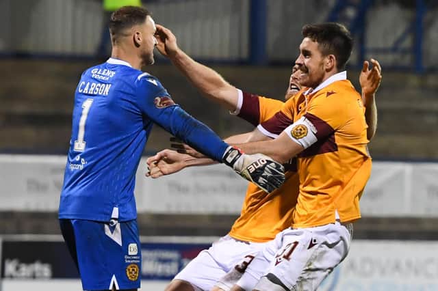 Motherwell goalkeeper Trevor Carson (L) celebrates winning the penalty shootout with Declan Gallagher and Stephen O'Donnell after the Europa League qualifier in Coleraine. (Photo by Ross MacDonald / SNS Group)