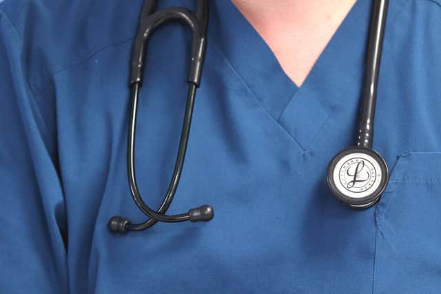 Adoctor holding a stethoscope. Lynne Cameron/PA Wire
