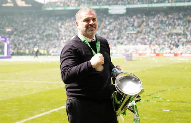 Celtic manager Ange Postecoglou celebrates with the Premiership trophy.