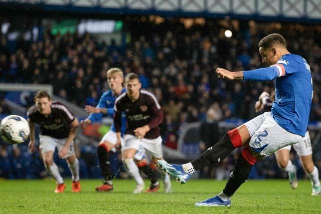 Rangers' James Tavernier scores from the spot, having earlier missed a penalty.