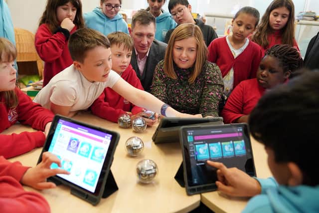 CGI’s Lyndsey Teaz and Andrew Fournet with the Technicoders at Corstorphine Primary. Image: Stewart Attwood Photography 2023.
