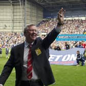 Alex Ferguson waves to fans before the start of the English Premier League football match between West Bromwich Albion and Manchester United, his last game before retirement, in 2013.