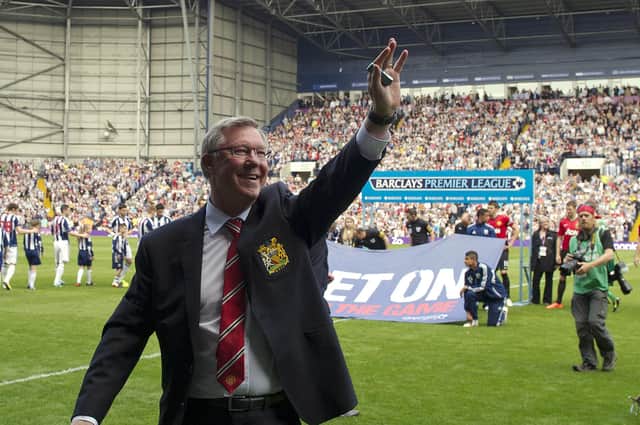 Alex Ferguson waves to fans before the start of the English Premier League football match between West Bromwich Albion and Manchester United, his last game before retirement, in 2013.