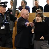 Police and security staff escort a protester from the public gallery during First Minister's Questions. Picture: Jeff J Mitchell/Getty Images