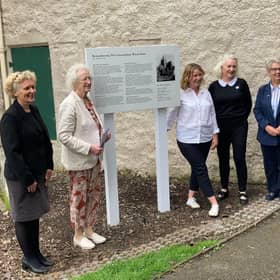 The plaque remembering the Corstorphine witches has been erected outside Dower House in Edinburgh.
