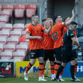 Referee Nick Walsh picks up a glass bottle that had been thrown onto the pitch as Dundee United's Tony Watt (arm raised) was celebrating scoring in front of the Raith Rovers fans   (Photo by Ewan Bootman / SNS Group)