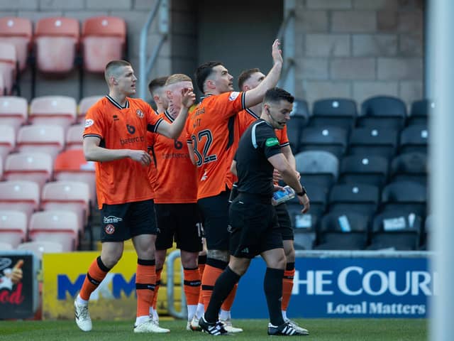 Referee Nick Walsh picks up a glass bottle that had been thrown onto the pitch as Dundee United's Tony Watt (arm raised) was celebrating scoring in front of the Raith Rovers fans   (Photo by Ewan Bootman / SNS Group)