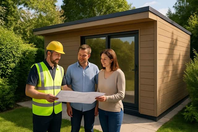 A My Outhouse Garden Rooms installer discusses plans with homeowners beside a freshly completed, composite-clad garden room—reflecting the firm’s new Which? Trusted Trader accreditation and focus on quality craftsmanship.