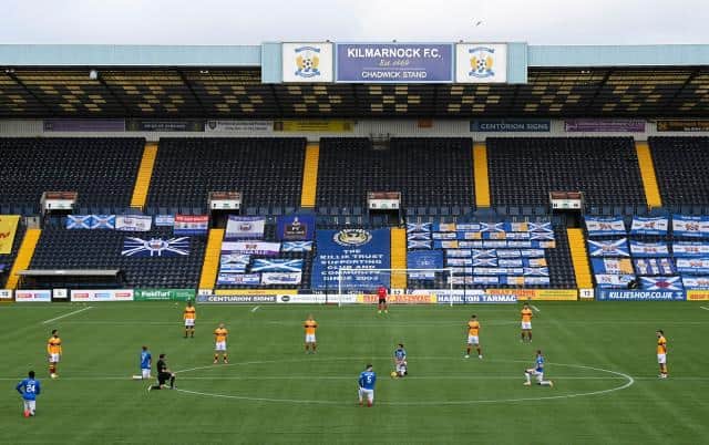 Motherwell stand against racism during the Scottish Premiership match between Kilmarnock and Motherwell at the BBSP Stadium on March 20, 2021, in Kilmarnock, Scotland. (Photo by Rob Casey / SNS Group)