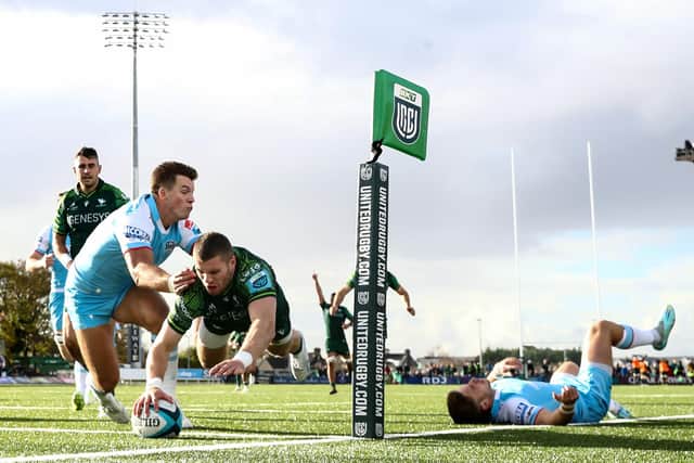 Connacht's Diarmuid Kilgallen dives to score the opening try despite Huw Jones of Glasgow Warriors. Pic: Ben Brady/INPHO/Shutterstock