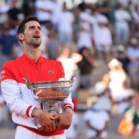 Novak Djokovic celebrates as he holds the trophy after winning the French Open final against Stefanos Tsitsipas at Roland Garros. (Photo by Clive Brunskill/Getty Images)