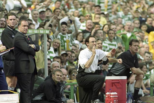 Celtic manager Martin O'Neill shouts instructions from the dugout as Rangers counterpart Dick Advocaat watches on during an Old Firm match in 2000.