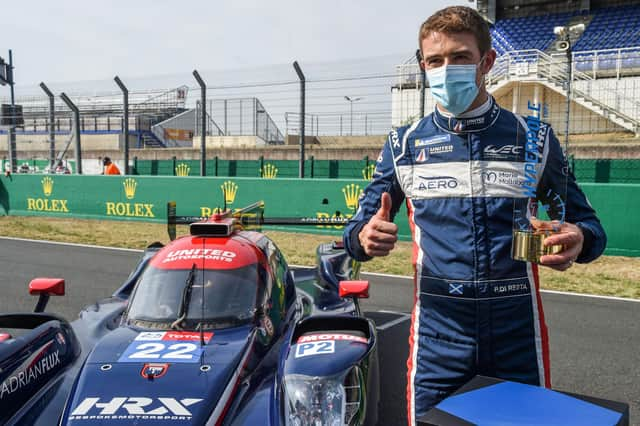 Paul Di Resta poses by his Oreca 07-Gibson LMP2 WEC racing car during the 88th edition of the Le Mans 24 Hours endurance race.