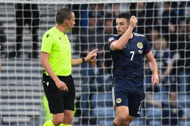 Scotland's John McGinn (R) complains to referee Sebastian Gishamer after an Armenian player throws a water bottle during a UEFA Nations League match between Scotland and Armenia at Hampden Park, on June  08, 2022, in Glasgow, Scotland. (Photo by Ross MacDonald / SNS Group)
