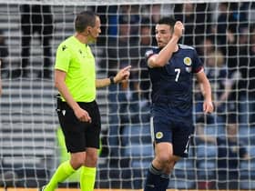 Scotland's John McGinn (R) complains to referee Sebastian Gishamer after an Armenian player throws a water bottle during a UEFA Nations League match between Scotland and Armenia at Hampden Park, on June  08, 2022, in Glasgow, Scotland. (Photo by Ross MacDonald / SNS Group)