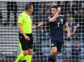 Scotland's John McGinn (R) complains to referee Sebastian Gishamer after an Armenian player throws a water bottle during a UEFA Nations League match between Scotland and Armenia at Hampden Park, on June  08, 2022, in Glasgow, Scotland. (Photo by Ross MacDonald / SNS Group)
