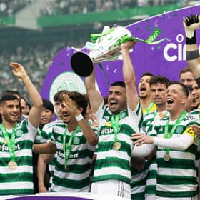 Celtic's Greg Taylor lifts the Premiership trophy after the 5-0 win over Aberdeen. (Photo by Craig Williamson / SNS Group)