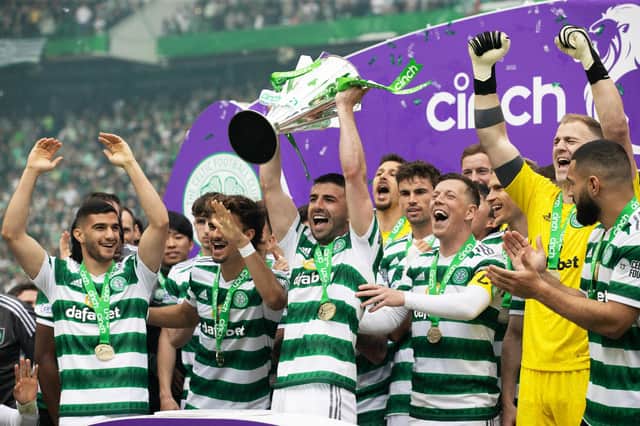 Celtic's Greg Taylor lifts the Premiership trophy after the 5-0 win over Aberdeen. (Photo by Craig Williamson / SNS Group)